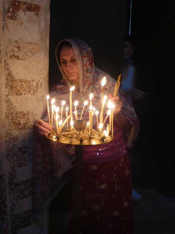 Khato places a candle.